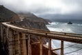 Bixby Bridge along Big Sur Rocky Coastline with Pacific Ocean Waves and Cloudy Sky Royalty Free Stock Photo