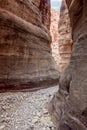 The bizarre beauty of high mountains on sides of gorge of the tourist route of the gorge Wadi Al Ghuwayr or An Nakhil and the wadi Royalty Free Stock Photo