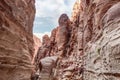 The bizarre beauty of high mountains on the sides of the gorge of the tourist route of the gorge Wadi Al Ghuwayr or An Nakhil and Royalty Free Stock Photo