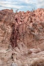 The bizarre beauty of high mountains on sides of gorge of tourist route of gorge Wadi Al Ghuwayr or An Nakhil and the wadi Al Royalty Free Stock Photo