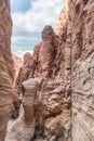 The bizarre beauty of high mountains on sides of the gorge of the tourist route of the gorge Wadi Al Ghuwayr or An Nakhil and the Royalty Free Stock Photo