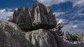 A bizarre black rock with sharp peaks against a background of blue sky Royalty Free Stock Photo