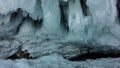 Bizarre stalactite icicles cover the base of the rock. Royalty Free Stock Photo