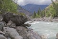 Bizarre stone on the shore of a mountain river. Altai Mountains