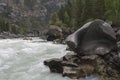 Bizarre stone on the shore of a mountain river. Altai Mountains