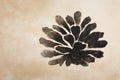 Black abstract flower shape print rests upon a textured light beige background with ample copy space on the left side. Royalty Free Stock Photo