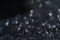 Black abstract glitter background with shiny bokeh