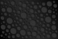 Black abstract perforated background, grey perforated circles with shadows Royalty Free Stock Photo