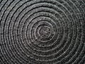 Black abstract woven surface with spiral circles