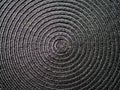 Black abstract woven surface with spiral circles