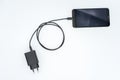 Black AC charger and USB cable connected to mobile phone Royalty Free Stock Photo