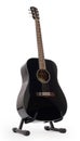 Black acoustic guitar on stand, isolated Royalty Free Stock Photo