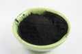 Black activated charcoal powder in a bowl Royalty Free Stock Photo
