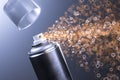 Black Aerosol Paint Can With Empty Space Spraying Golden Sparks On Blue Background. 3d rendering. Minimalism. Royalty Free Stock Photo