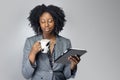 Black Female Businesswoman Keynote Speaker Posing with a Tablet and Coffee