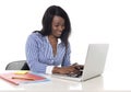 Black african american ethnicity woman working at computer laptop at office desk smiling happy