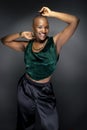 Black Female Fashion Model with Bald Hairstyle and Green Clothing Royalty Free Stock Photo