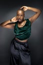 Black Female Fashion Model with Bald Hairstyle and Green Clothing Royalty Free Stock Photo