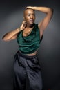 Black Female Fashion Model with Bald Hairstyle and Green Clothing Royalty Free Stock Photo