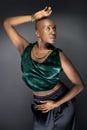 Black Female Fashion Model with Bald Hairstyle and Green Clothing Royalty Free Stock Photo