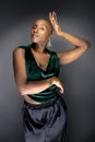 Black Female Fashion Model with Bald Hairstyle and Green Clothing Royalty Free Stock Photo