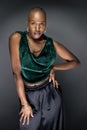 Black Female Fashion Model with Bald Hairstyle and Green Clothing Royalty Free Stock Photo