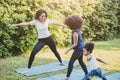 Black African American mom with child playing yoga family activity together at backyard during self quarantine at home