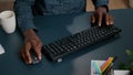 Black african american person typing on PC keyboard