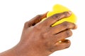 Black African American Woman`s hand holding yellow washing cleaning sponge isolated on a white background. Woman hand holding a cl Royalty Free Stock Photo