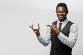 Black african business man points to his phone. Electronic store worker. Successful people lifestyle advert. You can win Royalty Free Stock Photo