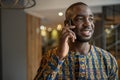 Black african businessman wearing traditional clothing, mobile phone Royalty Free Stock Photo