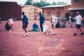 Black african children, boys and adults playing soccer with caucasian volunteers Royalty Free Stock Photo