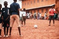 Black african children, boys and adults playing soccer