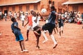 Black african children, boys and adults playing soccer