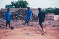 Black african children playing soccer in a rural area