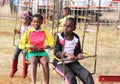 Black African children waiting for roundabout ride to start Royalty Free Stock Photo