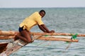 Black African fisherman, untie rigging sailing fishing boat.