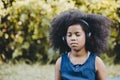 Black african girl children using headphones listening music eyes closed focus and concentrate at green park outdoor Royalty Free Stock Photo