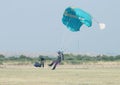 Black African male skydiver making safe landing on grass with op Royalty Free Stock Photo