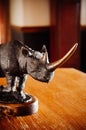 Black African Rhinoceros rhino vintage classic metal sculpture on wood table - Close up detail Royalty Free Stock Photo