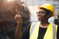 Black African smart women engineer worker finger point counting stock in factory industry warehouse proud smiling