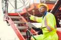 Black African Staff foreman intend to work loading worker using laptop computer to control cargo shipping in logistic warehouse