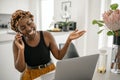 Black African traditional business woman working from home on phone call Royalty Free Stock Photo