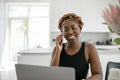 Black African traditional business woman working from home on phone call Royalty Free Stock Photo