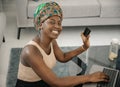 Black African woman at home, online shopping, using laptop and credit card