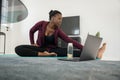 Black African woman online workout fitness class, stretching at home Royalty Free Stock Photo