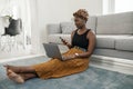 Black African woman working in comfort in living room at home Royalty Free Stock Photo