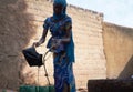 Black African Women Pouring Water into Bucket