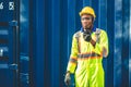 Black African worker working in logistic shipping radio control order command loading containers at shipping port. staff cargo for