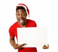 Black afro american man in Christmas Santa hat smiling happy showing blank billboard copy space Royalty Free Stock Photo